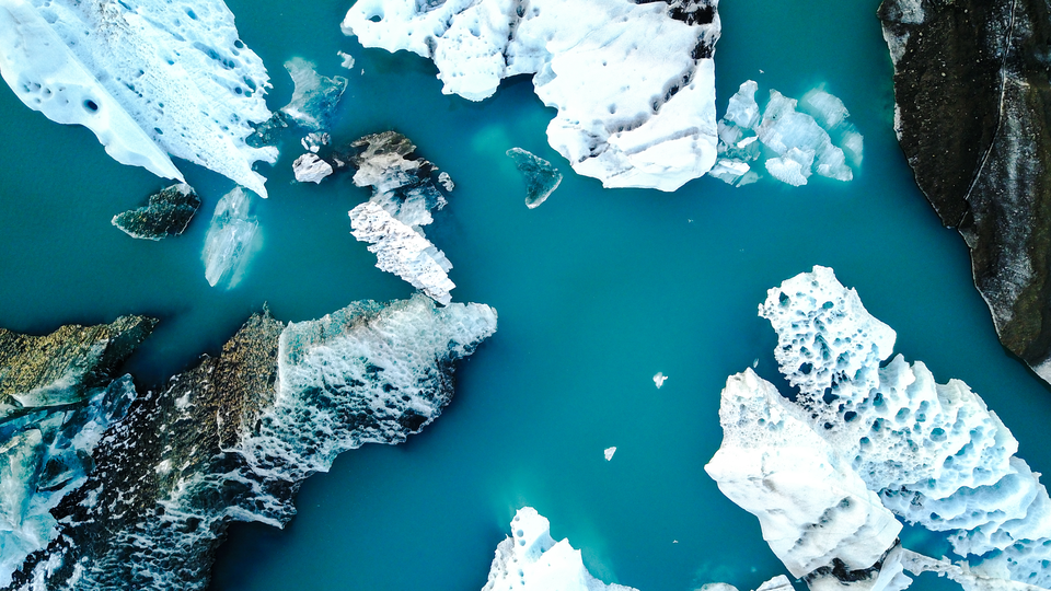 Aerial view of amazing glacier patterns and shapes in Jokulsarlon lake, Iceland. Glacial lagoon with icebergs floating. Climate change, global warming, melting glacier.